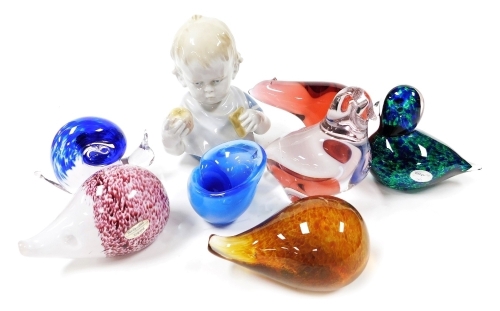 A group of glass paperweights, to include a Wedgwood model of a hedgehog, 13cm wide, a graduated blue shell, duck, etc.