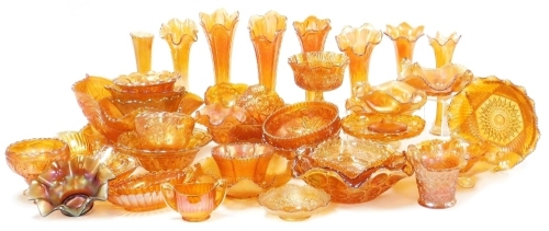 A large group of carnival amber glassware, including vases, bowls, sweetmeat dishes, and sundries. (a quantity)