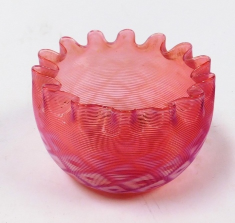 A Victorian pink and white vaseline glass bowl, with a crenilated edge, 11cm wide.