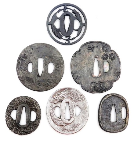 Six Japanese tsuba, of varying shapes and designs, depicting dragon, waves, blossom, etc., 7.5cm diameter.