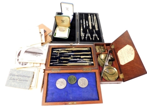 A group of collectables, to include two cased sets of drawing implements, commemorative crowns 1972 and 1977, souvenir postcards of Caltex for Port Elizabeth, bromite snap shots of Ypres, Bruges, Ostende, postcards from Cairo, etc., and other souvenir rel