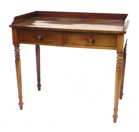 A Victorian mahogany side table, the top with a galleried back above two drawers, raised on turned tapering legs, 79cm high, 88cm wide, 50cm deep.