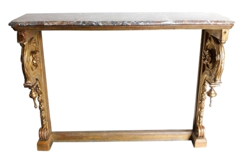 An early 19thC parcel gilt console table, the marble top with a shaped edge, the gilt wood base with floral and scroll carved decoration, 92cm high, 117cm wide, 41cm deep.