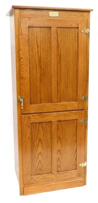 A White Clad Simmons Hardware Company St Louis USA oak cabinet, the panelled door enclosing a fitted interior, with a folding drop down table compartment, various shelves etc., 166cm high, 69cm wide, 55cm deep.