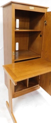 A White Clad Simmons Hardware Company St Louis USA oak cabinet, the panelled door enclosing a fitted interior, with a folding drop down table compartment, various shelves etc., 166cm high, 69cm wide, 55cm deep. - 2