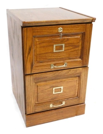 An oak two drawer filing cabinet, on a plinth base, 77cm high, 48cm wide, 58cm deep.