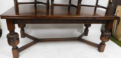 A Jay Cee furniture Jacobean style oak draw leaf dining table, the top with a rounded edge above four carved cup and cover legs, united by a H framed stretcher, 76cm high, the top 179cm x 93cm, together with a set of six oak Jacobean style carved dining c - 3