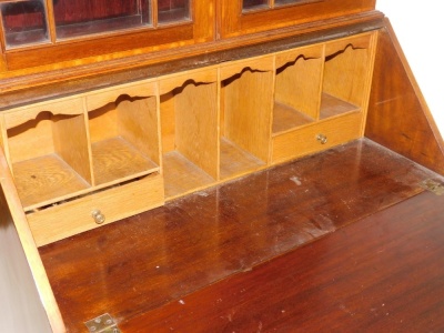 An Edwardian mahogany bureau bookcase, with satinwood cross banding, the outswept pediment with dentil moulding over a pair of astragal glazed doors enclosing two shelves, above a fall flap opening to reveal two drawers and six recesses, over three long g - 2