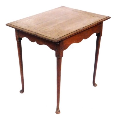 An early 20thC oak occasional table, the top with a moulded cornice above a shaped frieze, on turned tapering legs terminating in pad feet, 65cm high, 69cm wide, 54cm deep.