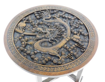 An Oriental hardwood occasional table, the top carved with a dragon among floral motifs, enclosed in a Greek key and floral carved border, with a glass removable top, on a gate leg type base, 64cm high, the top 60cm diameter. - 2