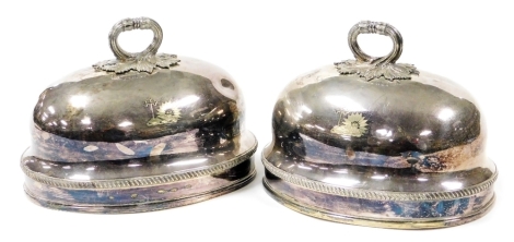 A pair of Victorian silver plated meat domes, crest engraved with foliate scrolled handles, stamped GRC, 29cm wide.