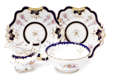 A pair of early 19thC Ridgway porcelain bread plates, painted with trailing flowers, against a cobalt blue and yellow ground, gilt heightened, pattern number 2/6788, together with a slop bowl, similarly decorated, pattern number 2/6660, and a slop bowl an