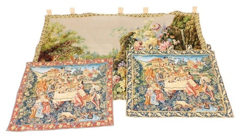 A French tapestry wall hanging, decorated with a village landscape and flowers, 219cm x 130cm, together with a pair of Buckingham tapestry wall hangings, decorated in the Garden Party pattern, 85cm x 112cm and 107cm x 84cm.