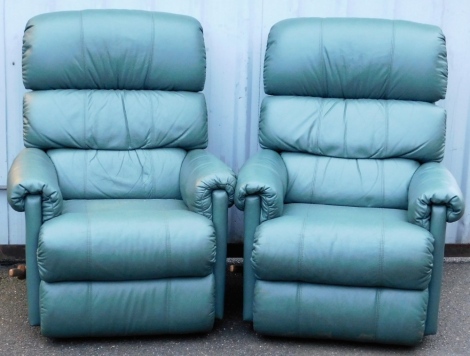 A pair of La-Z-Boy green leather recliner armchairs.