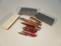 A collection of various ink pens and biros including a Conway fountain