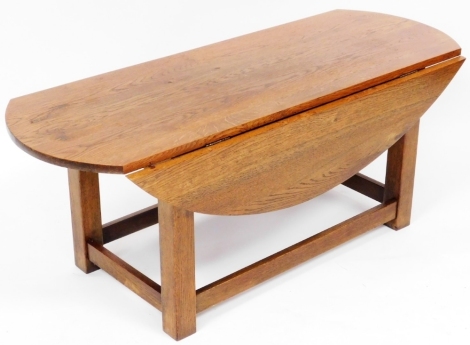 A 20thC oak dropleaf coffee table, raised on square legs united by a box stretcher, 47cm high, 120cm wide, 47cm deep, 89cm extended.