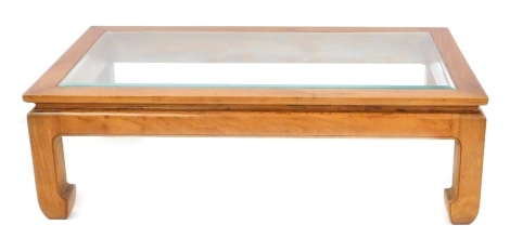 A Chinese hardwood and glass topped coffee table, of rectangular form raised on curved legs, 38cm high, 122cm wide, 71cm deep.