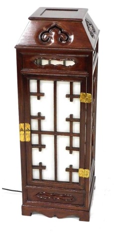 A Korean hardwood cased floor light, of square section with pierced and fabric back panelled sides, raised on bracket feet, 81cm high, 28cm wide, 28cm deep.