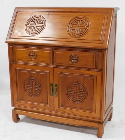 A Chinese hardwood bureau, the fall flap opening to reveal two central drawers and a recess, flanked by eight stationary recesses over two frieze drawers above cupboard doors, raised on bracket feet, 110cm high, 91cm wide, 42cm deep.