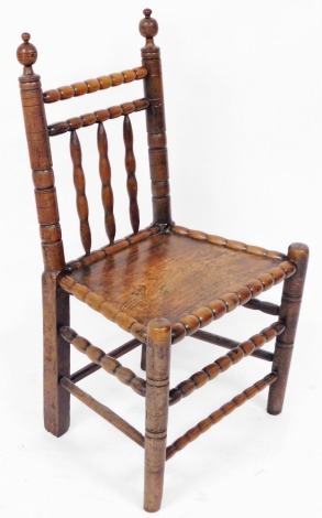 A Victorian ash and elm spindle back chair, with solid seat, raised on turned legs united by turned stretchers, 50cm wide.