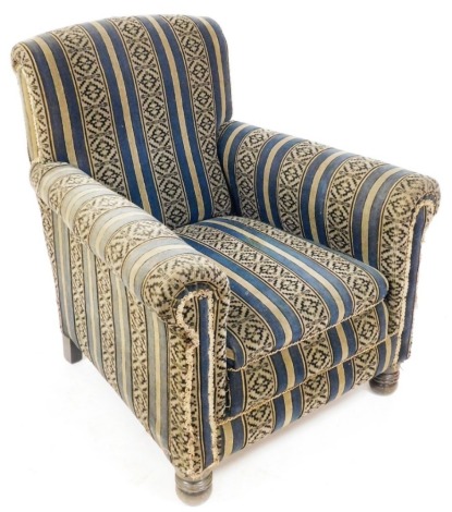 An early 20thC oak armchair, upholstered in striped fabric, raised on turned feet, 80cm wide.