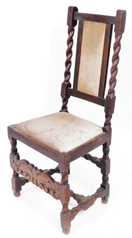 A Victorian Carolean style oak county chair, with an overstuffed back and drop in seat, raised on spiral twist and turned legs.