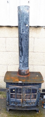 A Hunter cast iron log burner, with chimney flue, the log burner 55cm high, 56cm wide, 36cm deep.