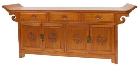 A Chinese hardwood altar sideboard, with three frieze drawers over two pairs of cupboard doors, raised on bracket feet, 88cm high, 215cm wide, 50cm deep.