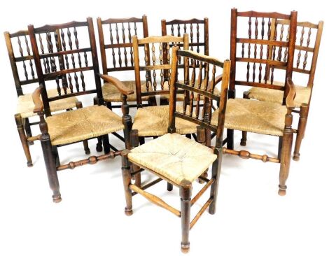 A 19thC oak and beech spindle back dining chairs, with rush seats, raised on turned legs united by turned stretchers, comprising a pair of carvers and six single chairs.