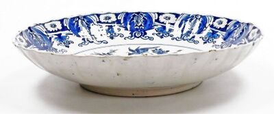 An 18thC Delft blue and white charger, with a waved border, the centre decorated with a vase surrounded by birds and flowers, within a repeating floral border, unmarked, 34.5cm diameter. - 3