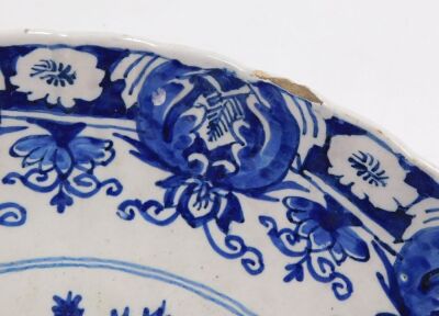 An 18thC Delft blue and white charger, with a waved border, the centre decorated with a vase surrounded by birds and flowers, within a repeating floral border, unmarked, 34.5cm diameter. - 4