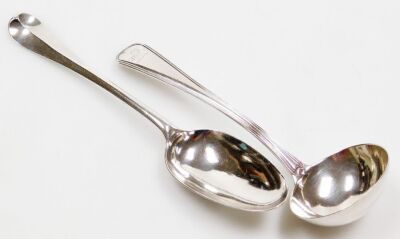 A Georgian silver rat-tail pattern serving spoon, hallmarks rubbed, 1.93oz, and a George III silver cream ladle, engraved crest, with ribbed banding, William Eley I & William Fearn, London 1807, 2.18oz, 17.5cm long.