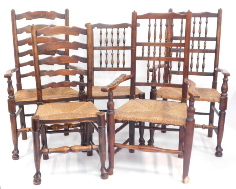 A harlequin set of five 18thC and later elm dining chairs, comprising a pair of spindle back carvers, a similar dining chair, together with a single carver and dining chair each with a ladder back, each with a rush seat.