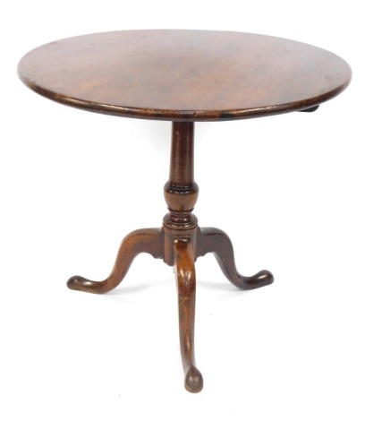 A George III mahogany tilt top occasional table, raised on a turned column, over three cabriole legs, 80cm diameter.