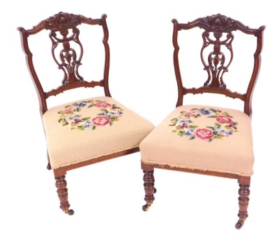 Two Victorian walnut nursing chairs, with tapestry seats. (2)