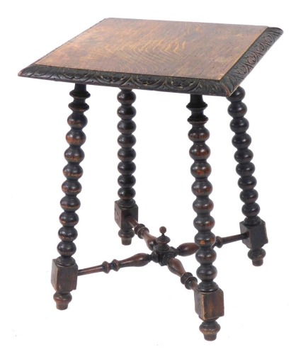 A Victorian oak occasional table, the square top with floral carved border, raised on bobbin turned legs united by an X frame turned stretcher, 59cm high, 45cm wide, 45cm deep.