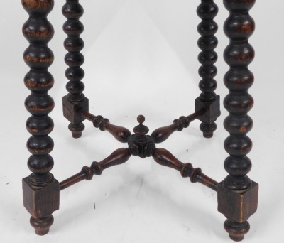 A Victorian oak occasional table, the square top with floral carved border, raised on bobbin turned legs united by an X frame turned stretcher, 59cm high, 45cm wide, 45cm deep. - 2