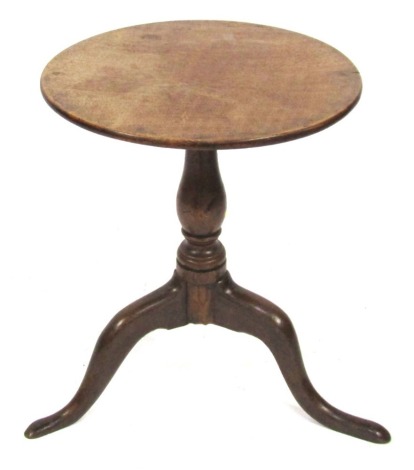 A George III mahogany occasional table, with a circular top raised on a baluster turned column over three cabriole legs, 59cm high, 48cm diameter.