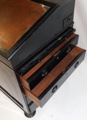 A Victorian ebonised Davenport, the hinged lid opening to reveal drawers and recesses, above a slide and four long drawers, raised on bun feet, 88cm high, 61cm wide, 61cm deep. - 4