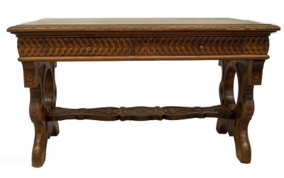 A 19thC Italian walnut centre table, with demi lune carved top, frieze drawers with carved decoration, refectory slab ends and carved stretcher, 78cm high, 129cm wide, 73cm deep. - 2