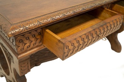 A 19thC Italian walnut centre table, with demi lune carved top, frieze drawers with carved decoration, refectory slab ends and carved stretcher, 78cm high, 129cm wide, 73cm deep. - 5