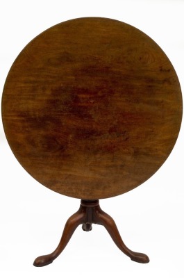 A Georgian mahogany supper table, with circular tilt top, resting on a bird cage, with gun barrel pillar and three out splayed legs with pad feet, 88cm diameter.