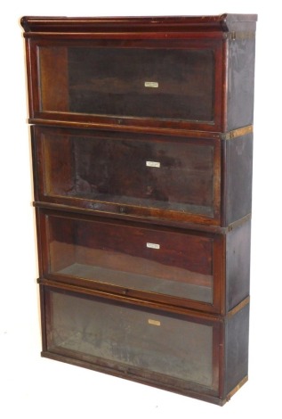 A Globe Wernicke Company Limited mahogany four section bookcase, with a pediment over four glazed up and over doors, 141cm high, 86.5cm wide, 27cm deep.