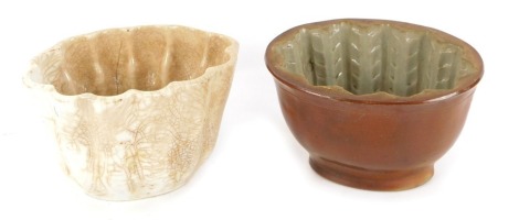 Two 19thC ceramic jelly moulds, comprising a white glazed finished mould, stamped Made in England with anchor crest, and marked Cornflour and Blancmange Brown & Polsons, 10cm high, and a brown treacle glazed fish mousse mould, 10cm high. (2)