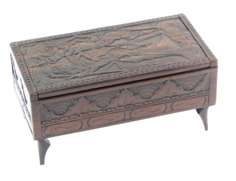 An Eastern carved wooden casket, decorated to the hinged lid with dancing figures, foliate carved frieze raised on shaped feet, 20cm wide.