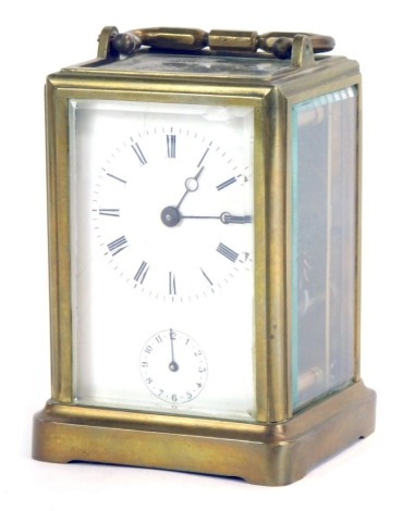 A 20thC brass carriage clock, with white Roman numeric dial and alarm dial, with a movement number 2704, with swing handle, 14cm high, 8cm wide, 6.5cm deep.