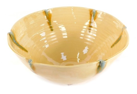 A Fenella Mallalieu studio pottery bowl, with six point flared turquoise rim, on a yellow ribbed ground, bearing signature, 16cm high, 33cm diameter.