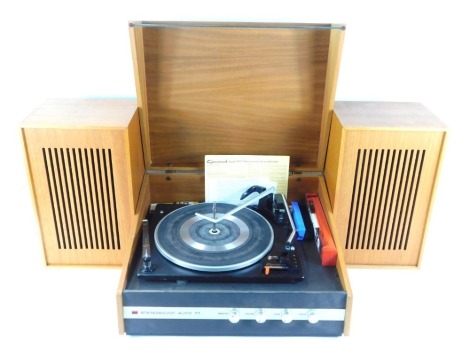 A Garrard automatic turntable, model 2025T, with stereo sound audio 77, and a pair of speakers.