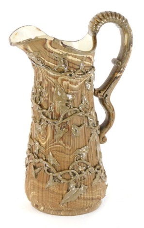 A Victorian agateware stoneware jug, in brown and cream, with applied vine and lily detail, with a white shield maker's mark to underside, 7cm high.