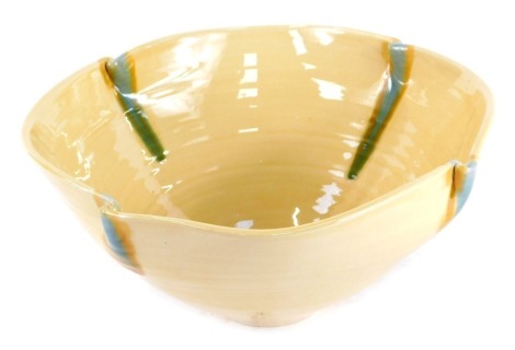 A Fenella Mallalieu studio pottery bowl, with four point flared turquoise rim, on a yellow ribbed ground, bearing signature, 13cm high, 27cm diameter.